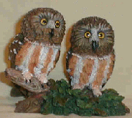 Figurine featuring 2 Saw-Whet Owls perched on a branch